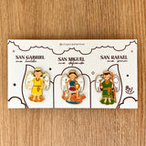 Three Archangels Catholic enamel pin kit — Saint Michael, Saint Gabriel and Saint Rafael kawaii pins on devotional presentation card — VII Sacramentos Colombia